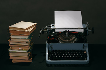 Image showing Old typewriter with books retro colors on the desk