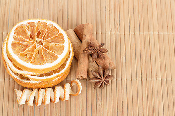 Image showing Star Anise, cinnamon and dried orange wooden background 