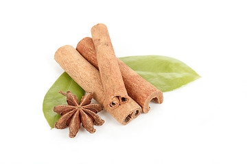 Image showing Star Anise, cinnamon and and green leave on white