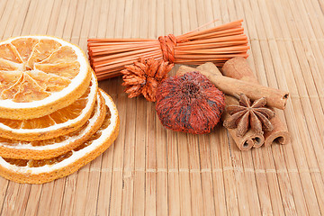 Image showing Star Anise, cinnamon and dried orange wooden background 