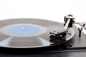 Image showing Spinning vinyl record. Motion blur image.  Vintage toned. 