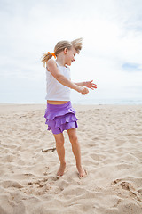 Image showing Young girl playing on beach