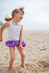 Image showing Young girl playing on beach