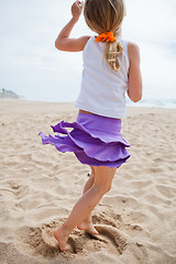 Image showing Young girl playing on beach