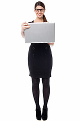 Image showing Smart businesswoman holding a laptop