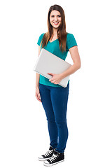 Image showing Casual attractive girl holding laptop