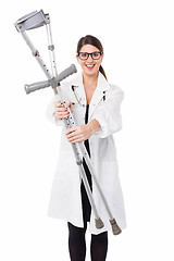 Image showing Female doctor displaying a set of crutches