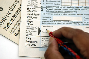 Image showing Signing a tax return