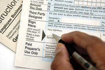 Image showing Signing a tax return