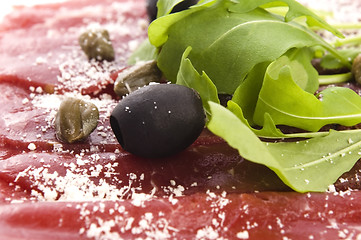 Image showing Beef carpaccio with rucola and parmesan 