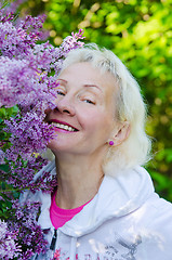 Image showing Portrait of a woman from a Bush blooming lilac 