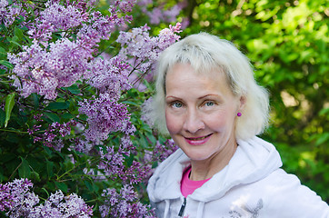Image showing Portrait of a woman from a Bush blooming lilac 