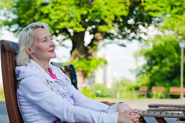 Image showing Portrait of a woman relaxing at a table summer Cafe