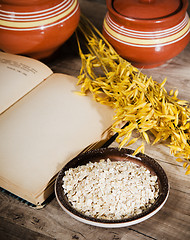 Image showing Still life with oatmeal and an open book