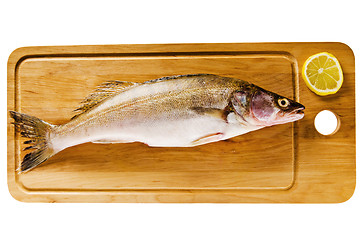 Image showing Pike perch on a wooden kitchen board, it is isolated on white