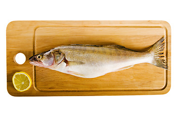 Image showing Pike perch on a wooden kitchen board, it is isolated on white