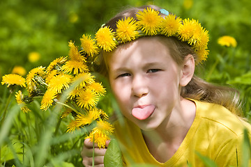 Image showing little girl in dandelion wreath showing her tongue