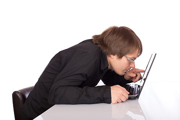 Image showing Sleepy business man look closely his laptop