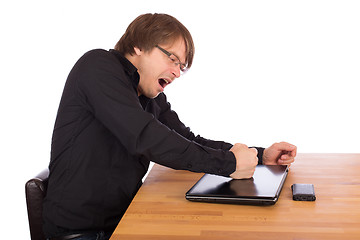 Image showing Angry man knock with his fist on his laptop