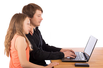 Image showing Father working with his daughter on a laptop