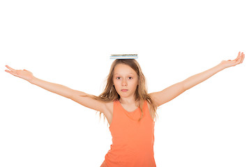 Image showing Child with a book on her head