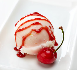 Image showing closeup of icecream scoop with sweet sauce and cherry