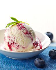 Image showing scoop of blueberry ice cream in white bowl