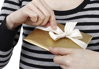 Image showing Young woman holding a present