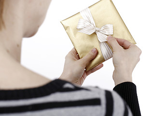 Image showing Young woman holding a present