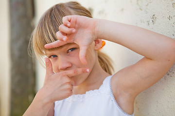 Image showing Young girl doing picture frame sign