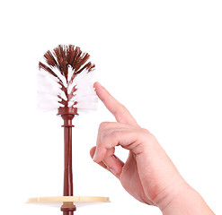 Image showing A toilet brush and a hand