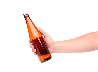 Image showing A hand holding up a yellow beer bottle