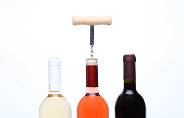 Image showing A set of three kinds of wine and corkscrew