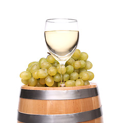 Image showing barrel, glass of wine and ripe grapes on wooden