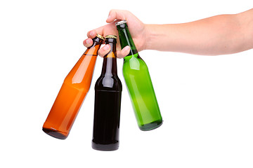 Image showing Man's hand holding three beer bottle