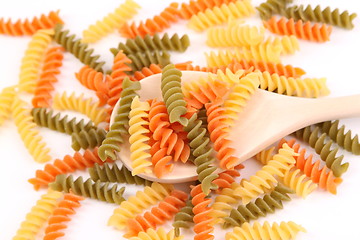 Image showing A pasta eliche tricolori and a wood spoon.