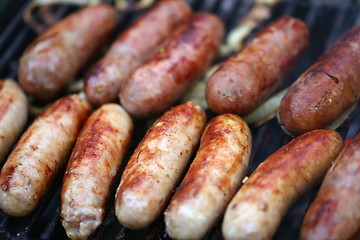 Image showing A lot of grilled sausages close up, barbecue