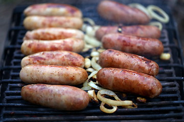 Image showing A lot of bratwurst sausages on grill.