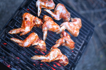 Image showing chicken wings being cooked on an outdoor barbeque