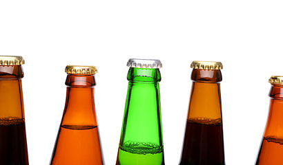 Image showing A row of top beer bottlenecks