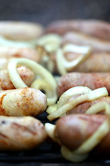 Image showing BBQ a lot of tips sausages with onion