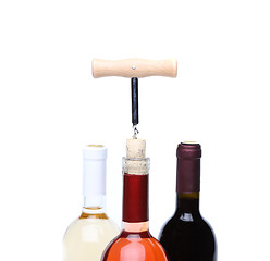 Image showing Opening three bottles of wine