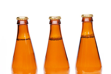 Image showing Three brown neck bottles