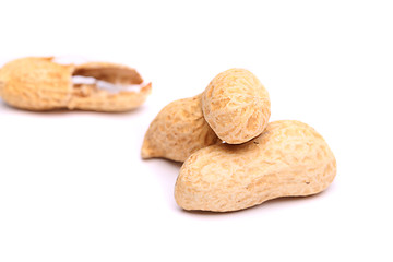 Image showing Three peanuts in closeup and peel