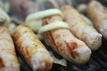 Image showing BBQ a few sausages with onion