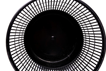 Image showing A top plastic trash can lying on its side close-up