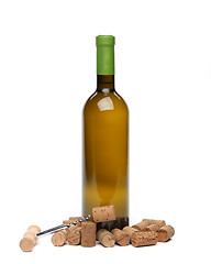 Image showing A bottle of wine, corks and corkscrew.