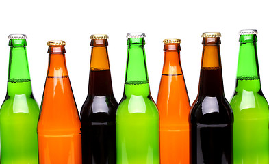 Image showing A row of top beer bottles