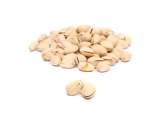 Image showing Two pistachios and hill of pistachios.