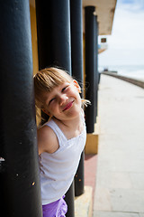 Image showing Young girl on beachside walkway